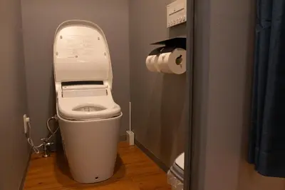 a bathroom with a toilet with the lid up at \u30a8\u30b3\u30ed\u65b0\u5bbf\u7b2c\u4e8c\u30d3\u30eb in Tokyo
