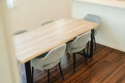 a wooden table with four chairs around it at Tokyo Platinum Comfort in Tokyo