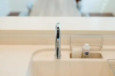 a sink with a toothbrush and a bottle of toothpaste at Tokyo Platinum Comfort in Tokyo