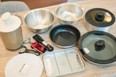 a table topped with pans and other kitchen utensils at Tokyo Platinum Comfort in Tokyo