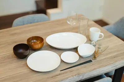 a wooden table with white plates on it at Tokyo Platinum Comfort in Tokyo