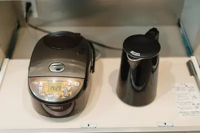 a toaster and a coffee pot sitting on a counter at Tokyo Platinum Comfort in Tokyo