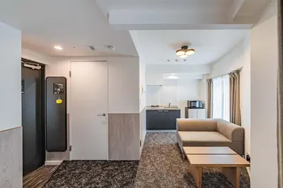 a living room with a couch and a table at Apartment Hotel 11 Asakusa 1 in Tokyo