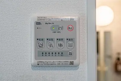 a white electrical switch on a white wall at Apartment Hotel 11 Asakusa 1 in Tokyo
