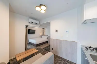 a hotel room with a bed and a kitchen at Apartment Hotel 11 Asakusa 1 in Tokyo