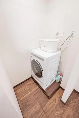 a washing machine in the corner of a room at Ueno home 10-minute walk from Ueno Station, 4-minute walk from Inaricho Station, 10-minute walk to Asakusa, 2nd and 3rd floors in Tokyo