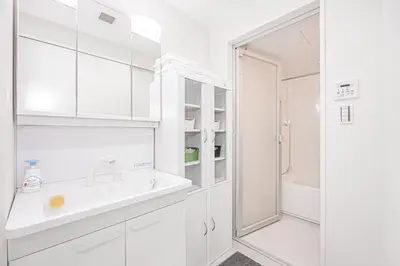 a white bathroom with a sink and a shower at Ueno home 10-minute walk from Ueno Station, 4-minute walk from Inaricho Station, 10-minute walk to Asakusa, 2nd and 3rd floors in Tokyo