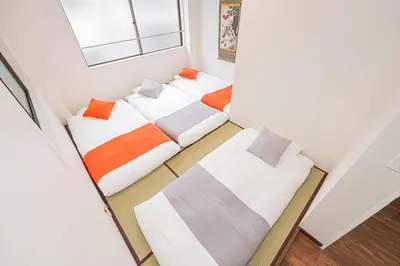 two beds in a small room at Ueno home 10-minute walk from Ueno Station, 4-minute walk from Inaricho Station, 10-minute walk to Asakusa, 2nd and 3rd floors in Tokyo