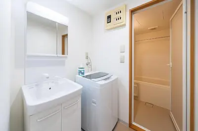 a white bathroom with a sink and a mirror at willcourt in Tokyo