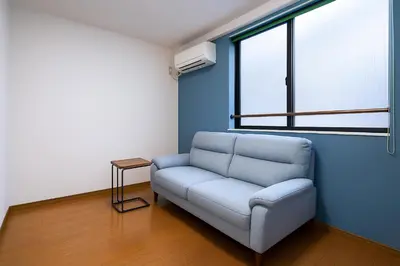 a living room with a couch and a window at willcourt in Tokyo