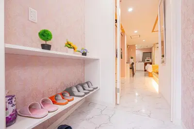 a room with a row of shoes sitting on a shelf at Ueno home2 10-minute walk from Ueno Station, 4-minute walk from Inaricho Station, 10-minute walk to Asakusa, 1F in Tokyo