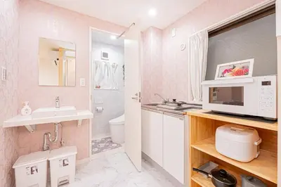 a bathroom with a sink and a toilet and a microwave at Ueno home2 10-minute walk from Ueno Station, 4-minute walk from Inaricho Station, 10-minute walk to Asakusa, 1F in Tokyo