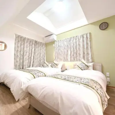 a bedroom with two beds with white sheets at \u6771\u7acb\u77f34\u4e01\u76ee-47 in Tokyo