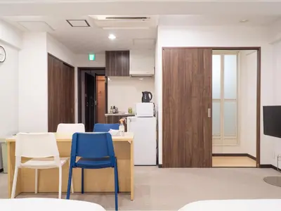 a kitchen with a table and chairs and a refrigerator at Shinjuku family apartment in Tokyo