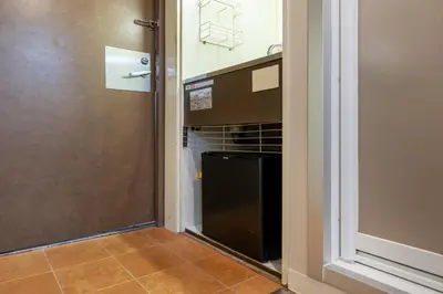 a kitchen with a black oven in a room at Sleep Inn Gotanda in Tokyo