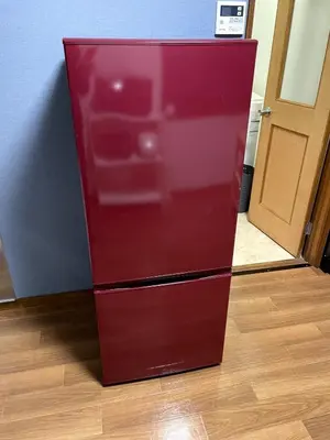 a red refrigerator is sitting on a wooden floor at Tokyo Stay sugamo House in Tokyo