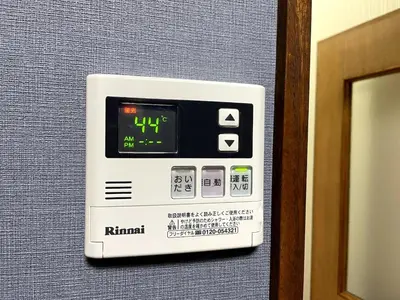 an alarm clock on the wall of a hotel room at Tokyo Stay sugamo House in Tokyo