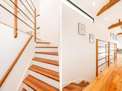 a staircase in a home with white walls and wooden floors at SkyTreeStayHotel 3, 8-minute walk from Yahiro Station, lovely new building, near Ara river, can see Sky Tree in Tokyo