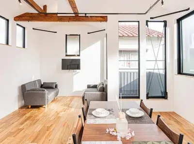a living room with a table and a couch at SkyTreeStayHotel 3, 8-minute walk from Yahiro Station, lovely new building, near Ara river, can see Sky Tree in Tokyo