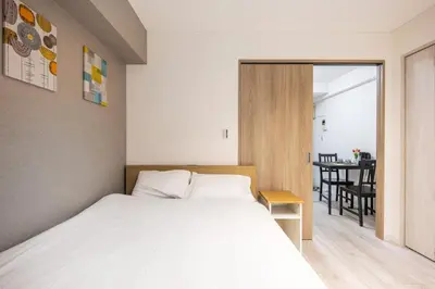 a bedroom with a bed and a dining room at 203 8 min walk to Ikebukuro 6 min walk to Kanamecho Station 25m Max 2 people Direct access to Tokyo, Shinjuku, Shibuya, Ueno in Tokyo