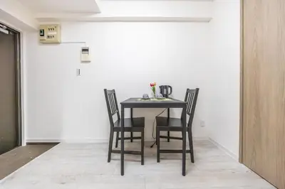a black table with four chairs in a room at 203 8 min walk to Ikebukuro 6 min walk to Kanamecho Station 25m Max 2 people Direct access to Tokyo, Shinjuku, Shibuya, Ueno in Tokyo