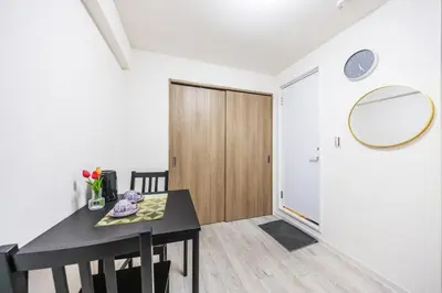 a dining room with a table and a mirror at Ikebukuro 8 min walk, Kanamecho 6 min walk, 25sqm room, 2 guests, Direct access to Shinjuku, Shibuya, Tokyo, Ueno, 1 double bed in Tokyo