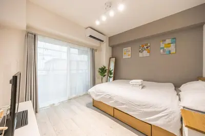 a bedroom with a bed and a large window at Ikebukuro 8 min walk, Kanamecho 6 min walk, 25sqm room, 2 guests, Direct access to Shinjuku, Shibuya, Tokyo, Ueno, 1 double bed in Tokyo