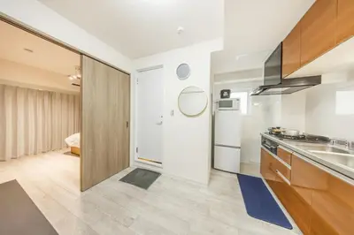a kitchen with a sink and a refrigerator at Ikebukuro 8 min walk, Kanamecho 6 min walk, 25sqm room, 2 guests, Direct access to Shinjuku, Shibuya, Tokyo, Ueno, 1 double bed in Tokyo