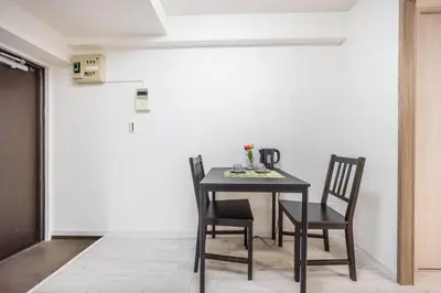 a black table and chairs in a room at Ikebukuro 8 min walk, Kanamecho 6 min walk, 25sqm room, 2 guests, Direct access to Shinjuku, Shibuya, Tokyo, Ueno, 1 double bed in Tokyo