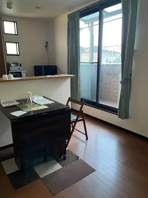a living room with a desk and a large window at Sky Tree Stay Hotel, 4-minute walk from Keisei Hikifune Station, detached house with parking, very convenient location in Tokyo