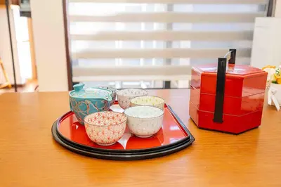 a tray with four cups on a table next to a box at Sky Tree Stay Hotel, 4-minute walk from Keisei Hikifune Station, detached house with parking, very convenient location in Tokyo