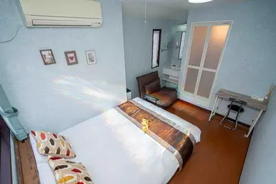 a bedroom with a large bed in a room at Sky Tree Stay Hotel, 4-minute walk from Keisei Hikifune Station, detached house with parking, very convenient location in Tokyo