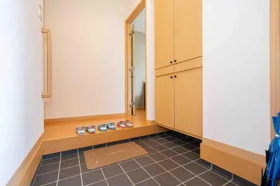 a room with a hallway with shoes on the floor at Sky Tree Stay Hotel, 4-minute walk from Keisei Hikifune Station, detached house with parking, very convenient location in Tokyo