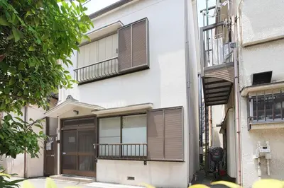 a white building with brown shutters on it at Skytree 1 Stop , 5-min Walk , 8 Guests , Fast WiFi in Tokyo