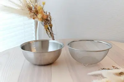 two metal bowls on a table with a vase of flowers at Skytree 1 Stop , 5-min Walk , 8 Guests , Fast WiFi in Tokyo