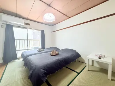 a bedroom with a bed with two stuffed animals on it at Tokyo Stay \u821e #201 in Tokyo