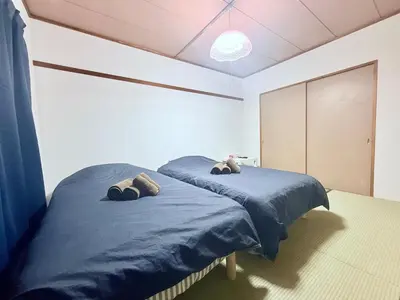 a bedroom with a blue bed with two pillows at Tokyo Stay \u821e #201 in Tokyo