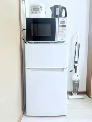 a microwave sitting on top of a white refrigerator at Tokyo Stay \u821e #201 in Tokyo