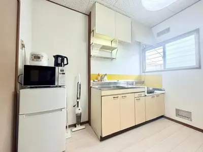 a kitchen with a white refrigerator and a microwave at Tokyo Stay \u821e #201 in Tokyo