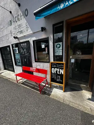 a red bench sitting in front of a store at K2 A house in Kita-senju in Tokyo