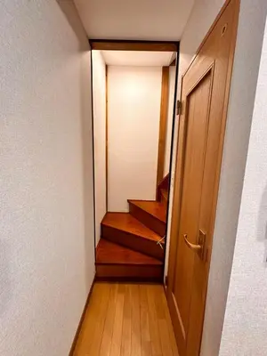 a hallway with a door and stairs in a room at K2 A house in Kita-senju in Tokyo