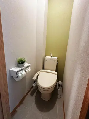 a small bathroom with a toilet and a plant at K2 A house in Kita-senju in Tokyo