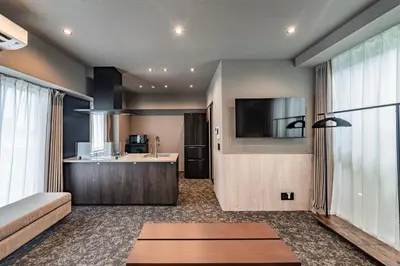 a kitchen and a living room with a couch and a table at Apartment Hotel 11 Asakusa 2 in Tokyo