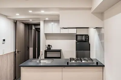 a kitchen with a sink and a stove at Apartment Hotel 11 Asakusa 2 in Tokyo