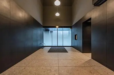 an empty hallway with glass doors and a tile floor at Apartment Hotel 11 Asakusa 2 in Tokyo