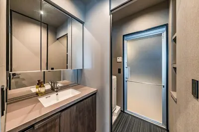 a bathroom with a sink and a shower at Apartment Hotel 11 Asakusa 2 in Tokyo