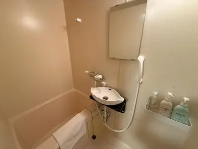 a bathroom with a sink and a bath tub at \u30b3\u30fc\u30dd\u5ca1\u5d0e301 in Tokyo