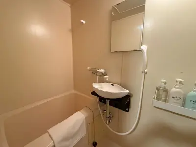 a bathroom with a sink and a bath tub at \u30b3\u30fc\u30dd\u5ca1\u5d0e301 in Tokyo