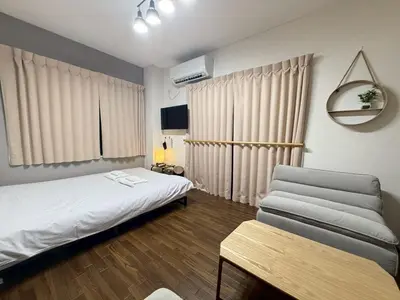 a bedroom with a bed and a table in it at \u30b3\u30fc\u30dd\u5ca1\u5d0e302 in Tokyo