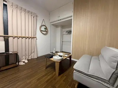 a living room with a couch and a table at \u30b3\u30fc\u30dd\u5ca1\u5d0e302 in Tokyo